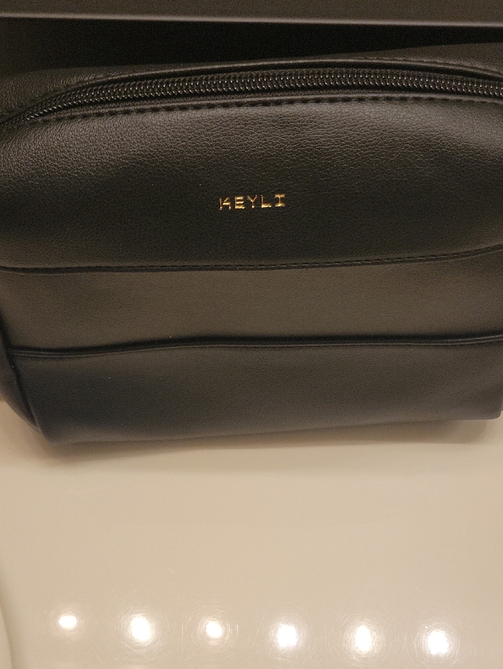 Black Leather Cosmetic Pouch with Gold Logo